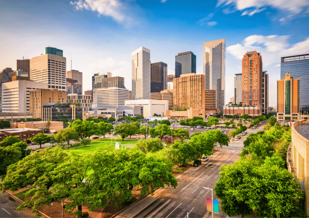 Houston skyline with modern skyscrapers, green parks, and city streets, representing senior care opportunities and community support for older residents.