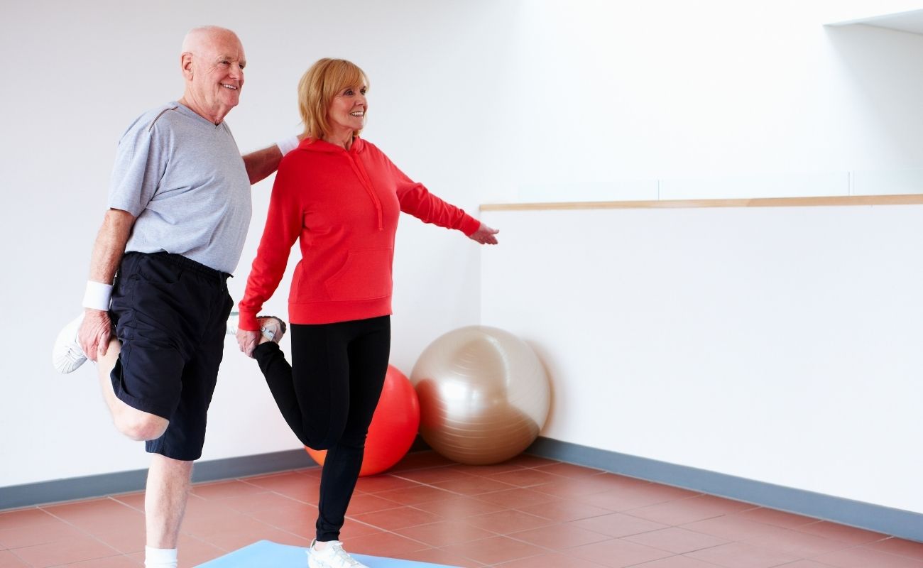 Senior Couple Balancing on One Leg