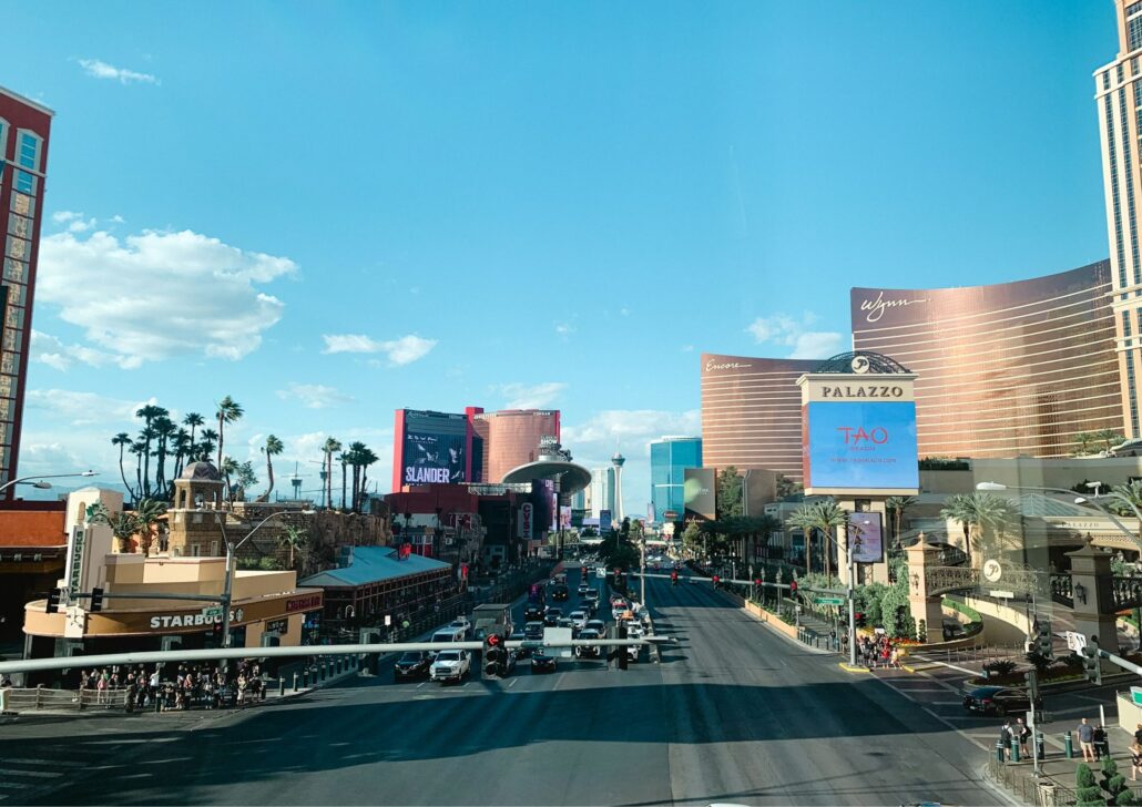 Las Vegas Strip view featuring iconic hotels and casinos, showcasing vibrant billboards and palm trees, symbolizing the lively atmosphere of the city, relevant to senior care community and services in Las Vegas.