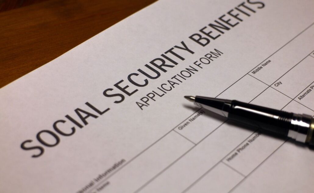 Social Security benefits application form with a pen, emphasizing retirement income planning and financial security for seniors.