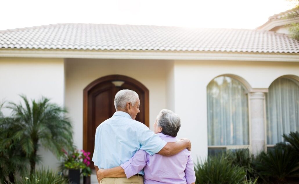 Senior couple looking at their house