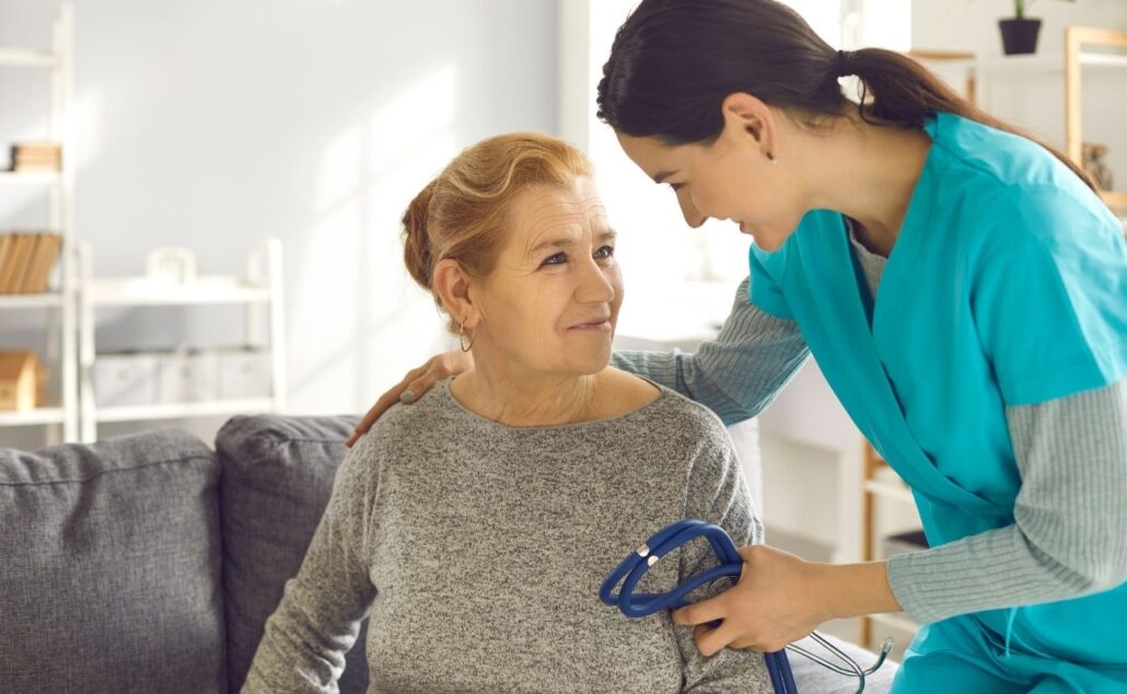 Doctor with Stethoscope Supporting Senior Woman during Health Screening at Clinic