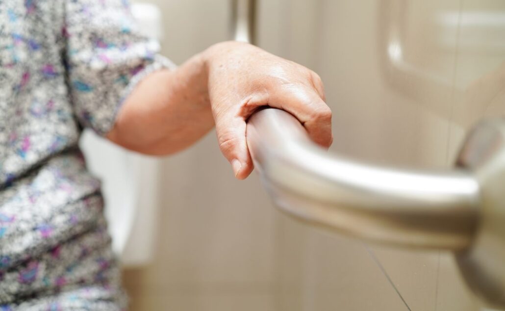 Elderly Person Holding on the Handrail