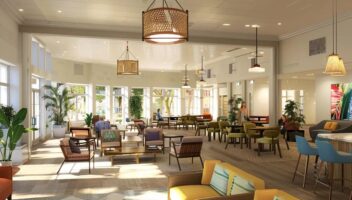 a warm, inviting assisted living common area features comfortable seating, engaged residents sharing stories, and bright, cheerful decor, emphasizing community and comfort during the transition.
